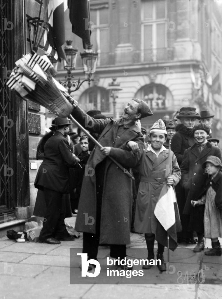 Flag-vendor and boy in the Rue St. Honore, Paris, 1918 (b/w photo)
