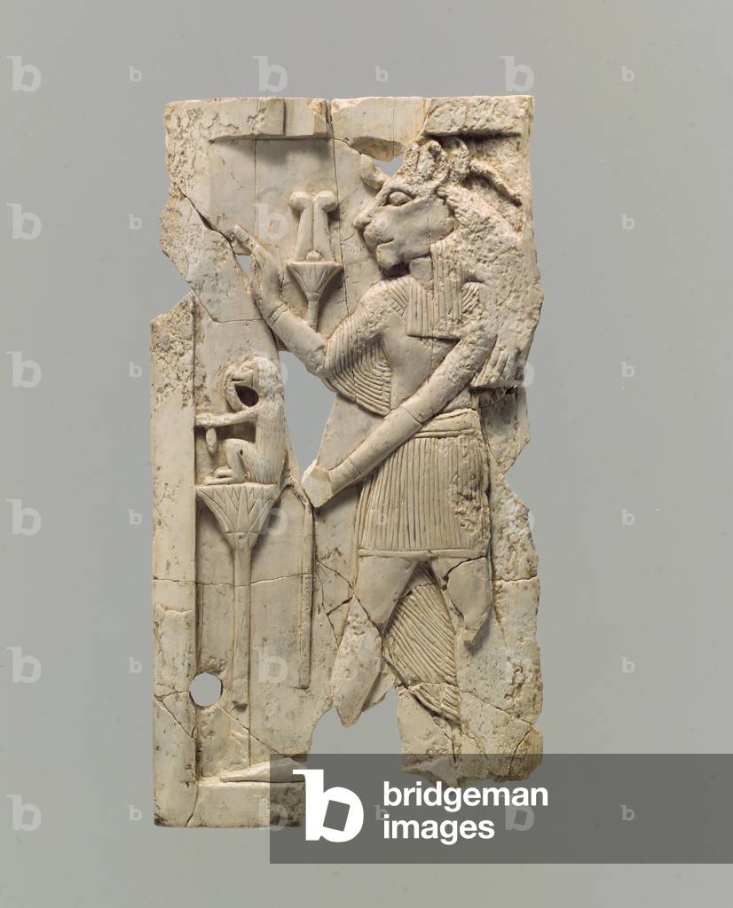 Furniture plaque carved in relief with lion-headed figure, c.8th–7th century B.C. (ivory)