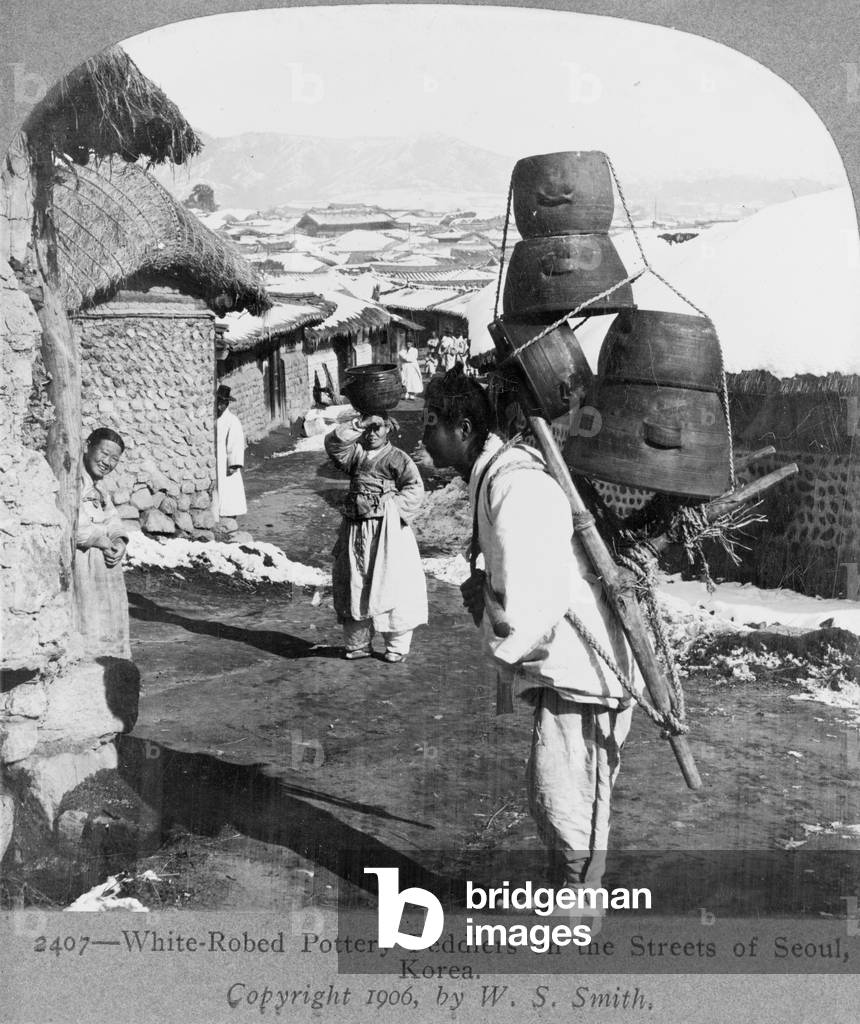 White-robed pottery peddlers on the streets of Seoul, Korea, c.1906 (b/w photo)