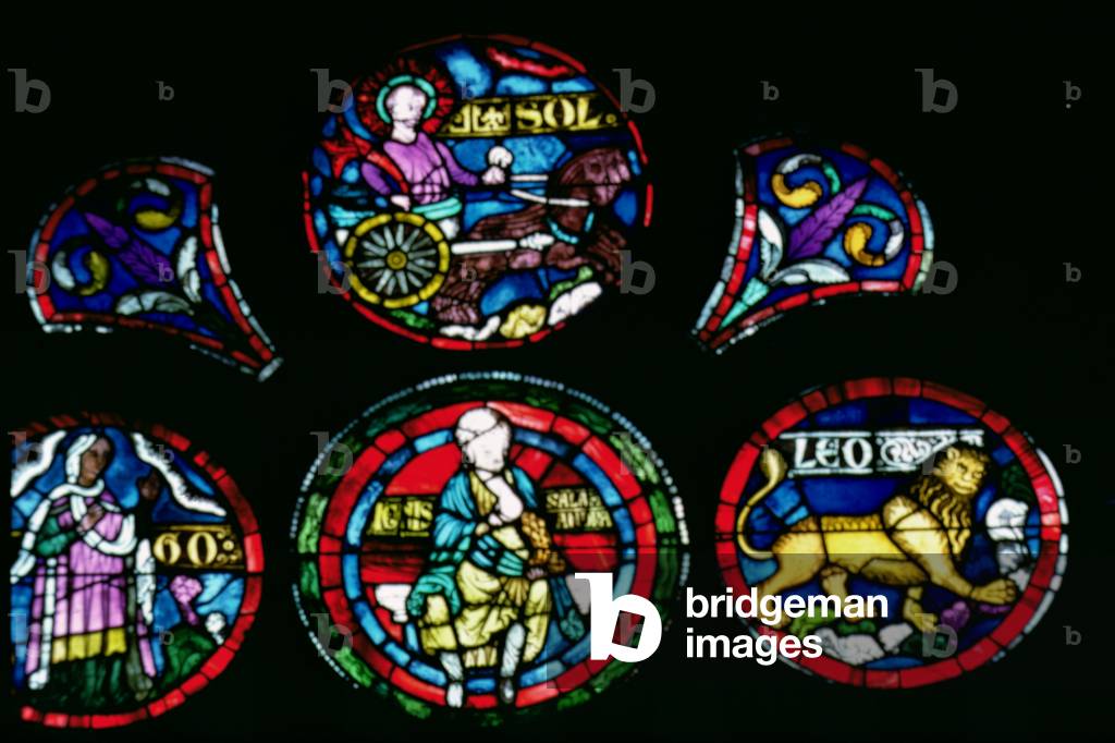 Stained Glass Rose Window depicting an Imago Mundi, detail of Fire, the Zodiac Sign of Leo and the Sun in a Chariot
