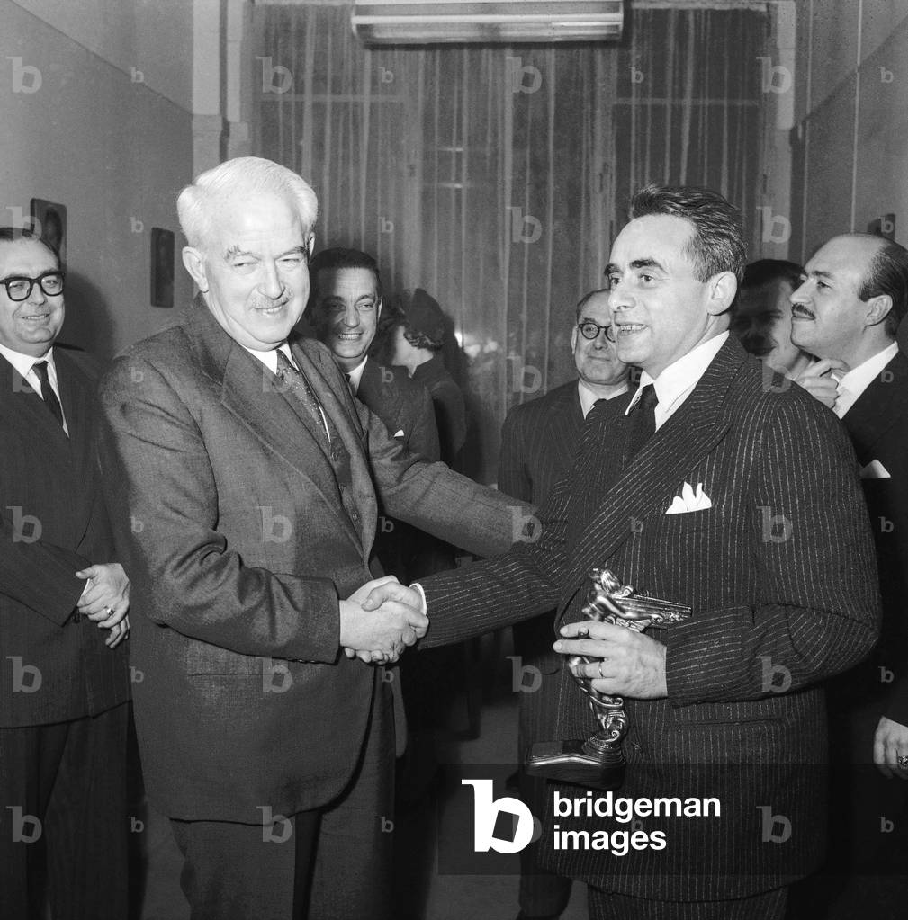 French director Henri Georges Clouzot has received the best director prize given by a Spanish jury, at UniFrance Films in Paris, February 3, 1955 : Marquis of Casa Roja (Spanish ambassador) and Henri Georges Clouzot (b/w photo)