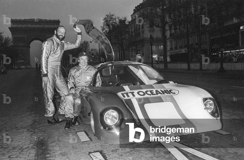 French pilots Jean-Pierre Beltoise and Henry Pescarolo with thei new car ITT Ocean on the Champs Elysees in Paris, May 8, 1979 (b/w photo)