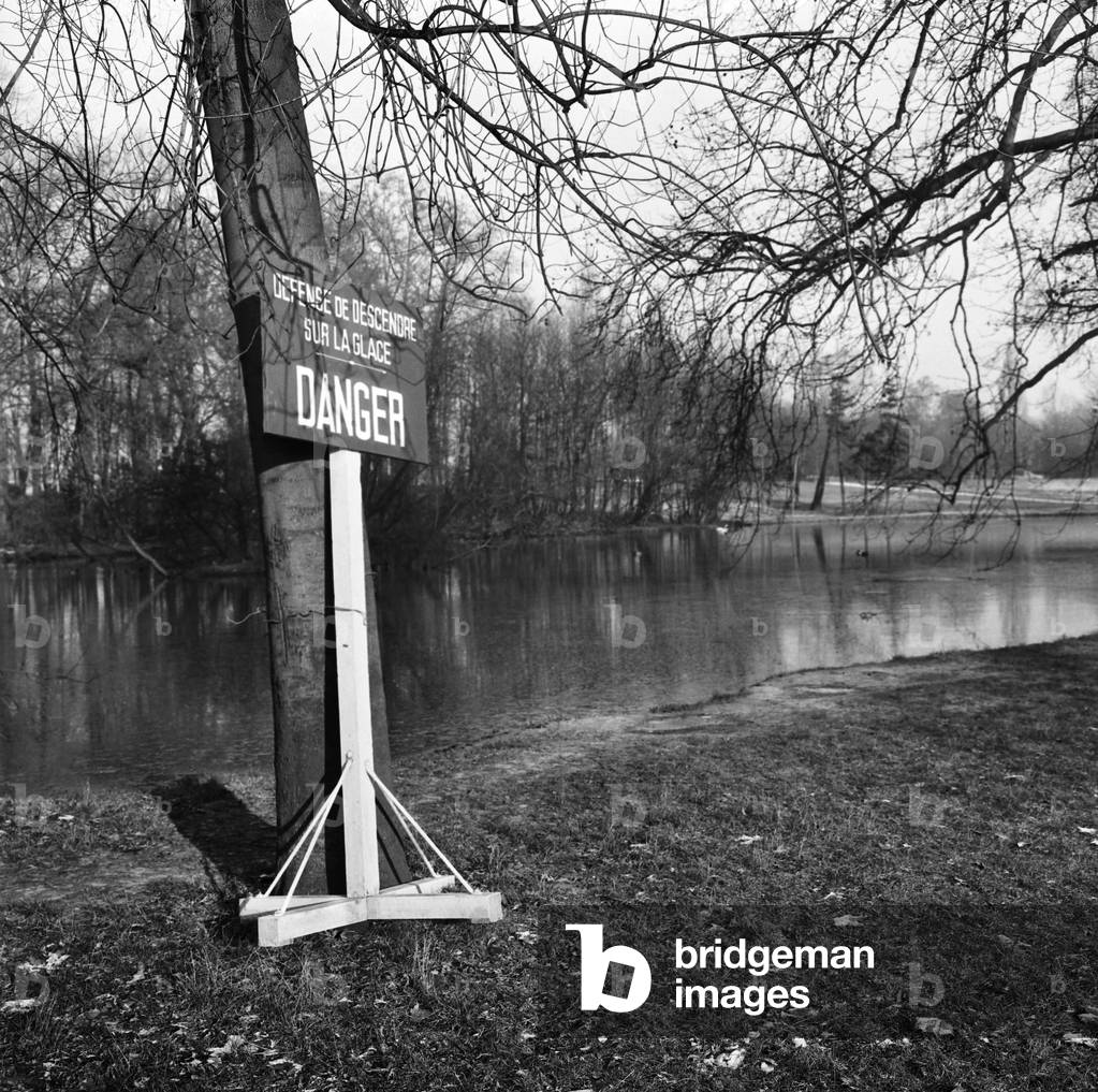 A sign indicating “Defense To Go Down On The Ice, Danger” Has Been Disposed In A Park, Here January 10, 1968 Neg: C78862 (b/w photo)