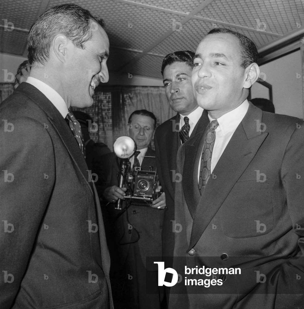 Prince Moulay Hassan (future king Hassan II of Morocco) arriving at Orly airport, Paris, welcome by Moroccan ambassador Abdellatif Ben Jelloun, April 4, 1959 (b/w photo)