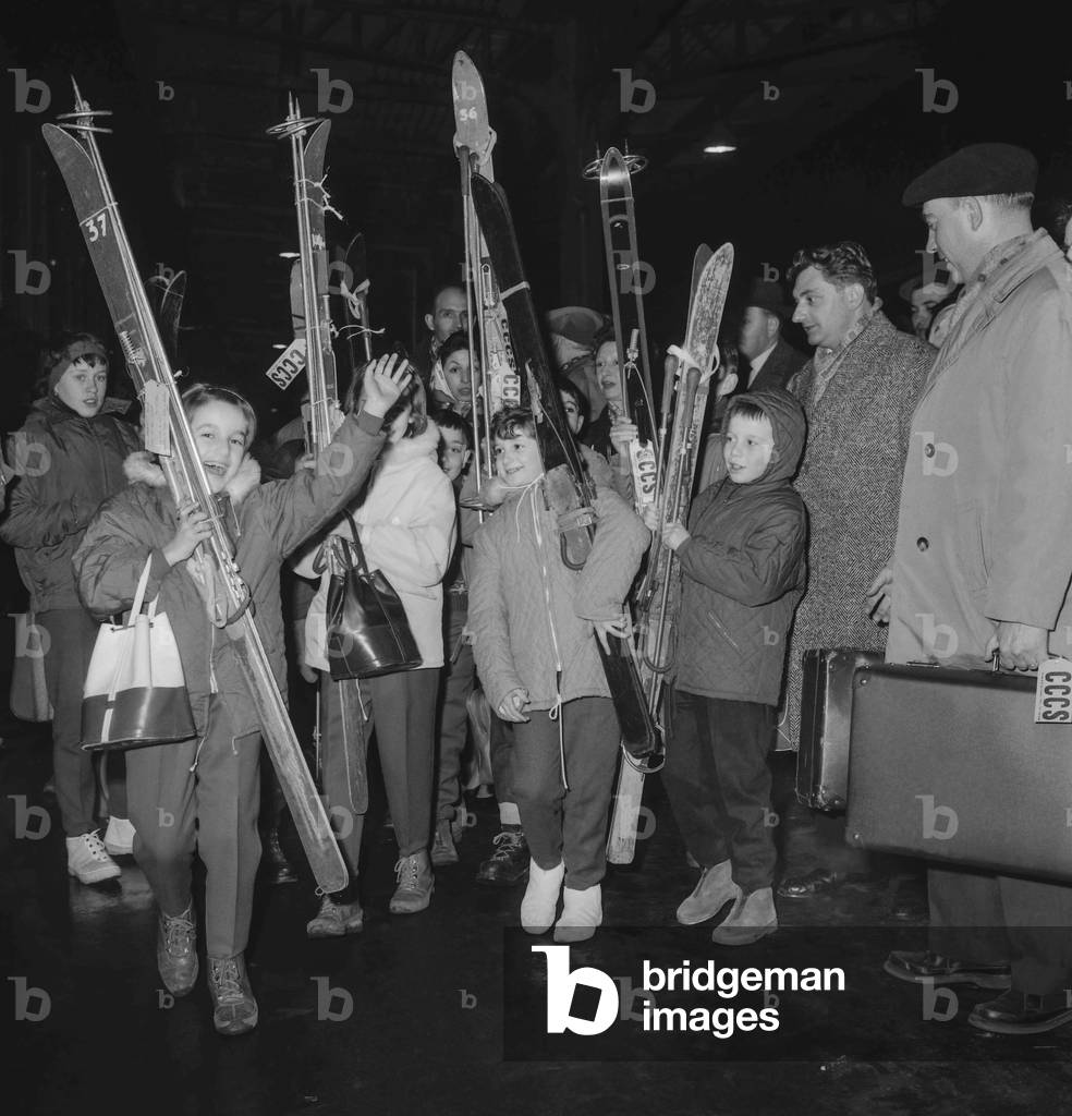 Departure for the holidays at the station in Paris on December 22, 1960 : children with skis (b/w photo)