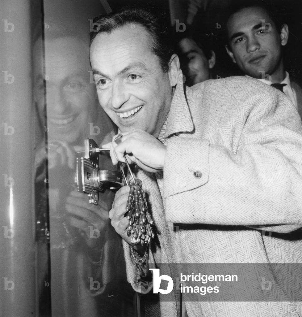 French Tv-Presenter Guy Lux Trying To Open The Safe at Gala For Premiere of Film Marnie in Paris November 7, 1964 (b/w photo)