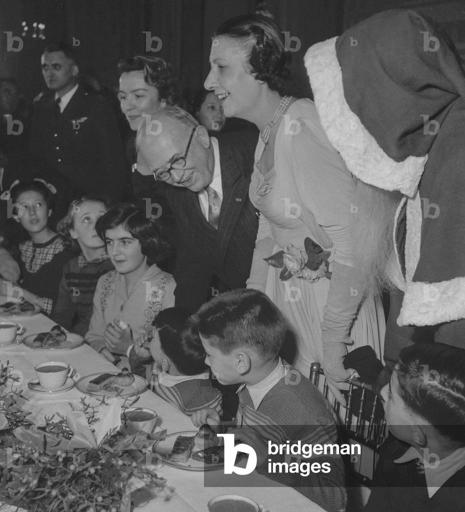 Celebration of Christmas at the Elysee, Paris, December 22, 1949 : French president Vincent Auriol with his wife Michelle Aucouturier, young children and Santa Claus (b/w photo)