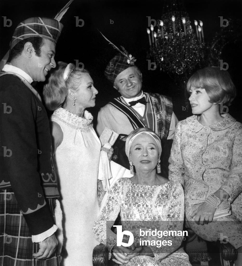 Arletty(Seated) Surrounded By L-R : Georges Guetary, Line Renaud, Jean Richard and Mony Dalmes during A Party at The Grand Palais in Paris (Biennial Festival of Antique Dealers) October 13, 1966 (b/w photo)