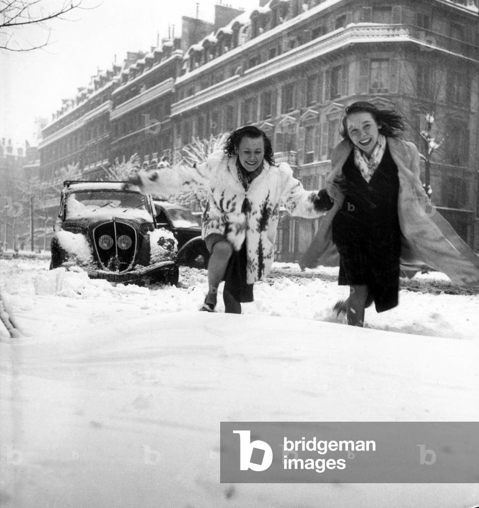 Young Woman Running in The Snow in Paris, 1946 (b/w photo)