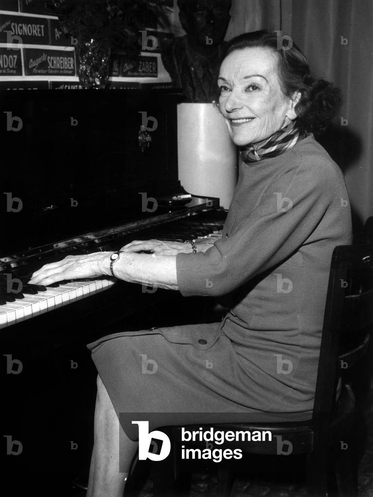 French Actress Mireille Balin At L'Association La Roule Turns In Front Of The Piano She Just Receive Thanks to Comedian Jacques Maurice March 31, 1967. (b/w photo)