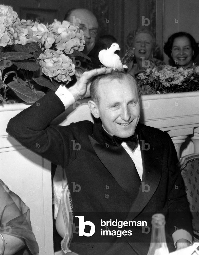 French Comedian Bourvil With Dove on his Head at Lasserre Restaurant in Paris May 6, 1953 (b/w photo)