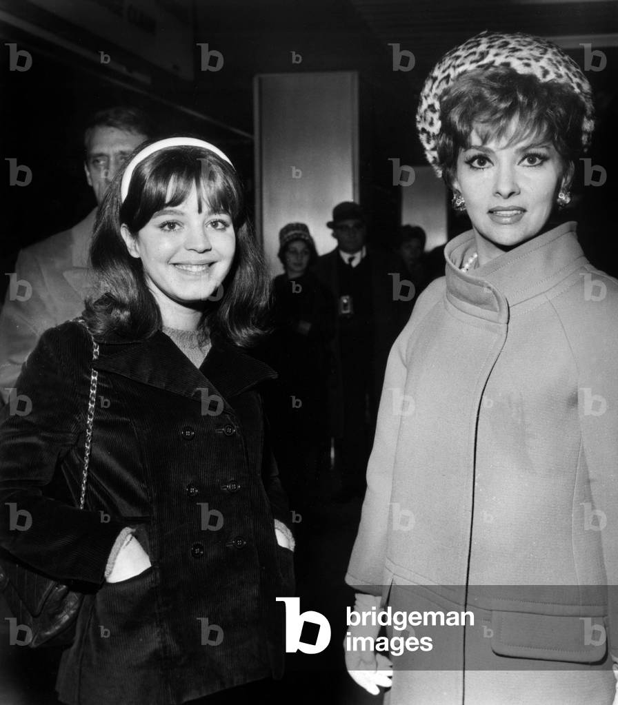Gina Lollobrigida Greets Her Arrival At Orly Airport By Muriel Baptiste Before Their Collaboration In The Film The Sultans December 14, 1965 (b/w photo)