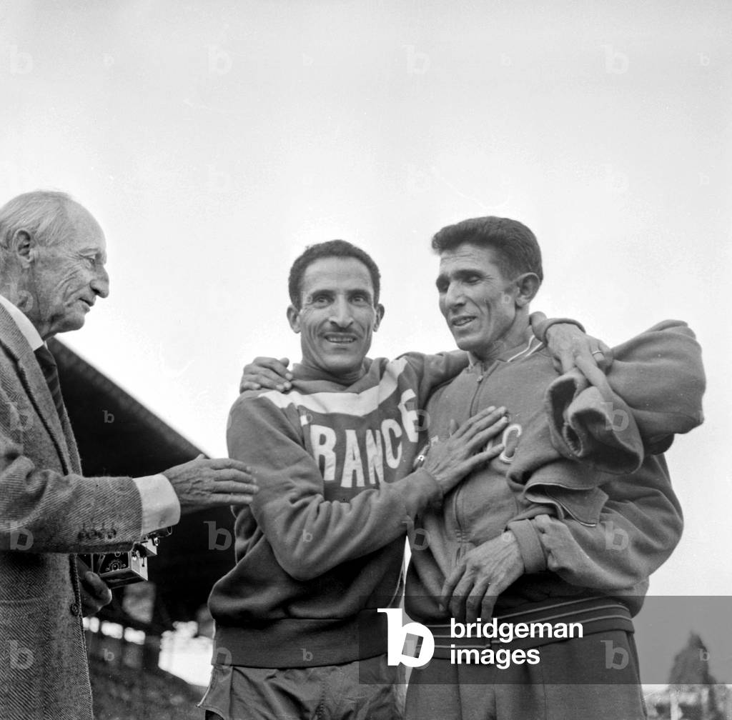 Athlets Alain Mimoun and Abdesselem Ben Rhadi After Victory of Mimoun at 1000M France-Sweden, Colombes, France, September 27, 1959 (b/w photo)