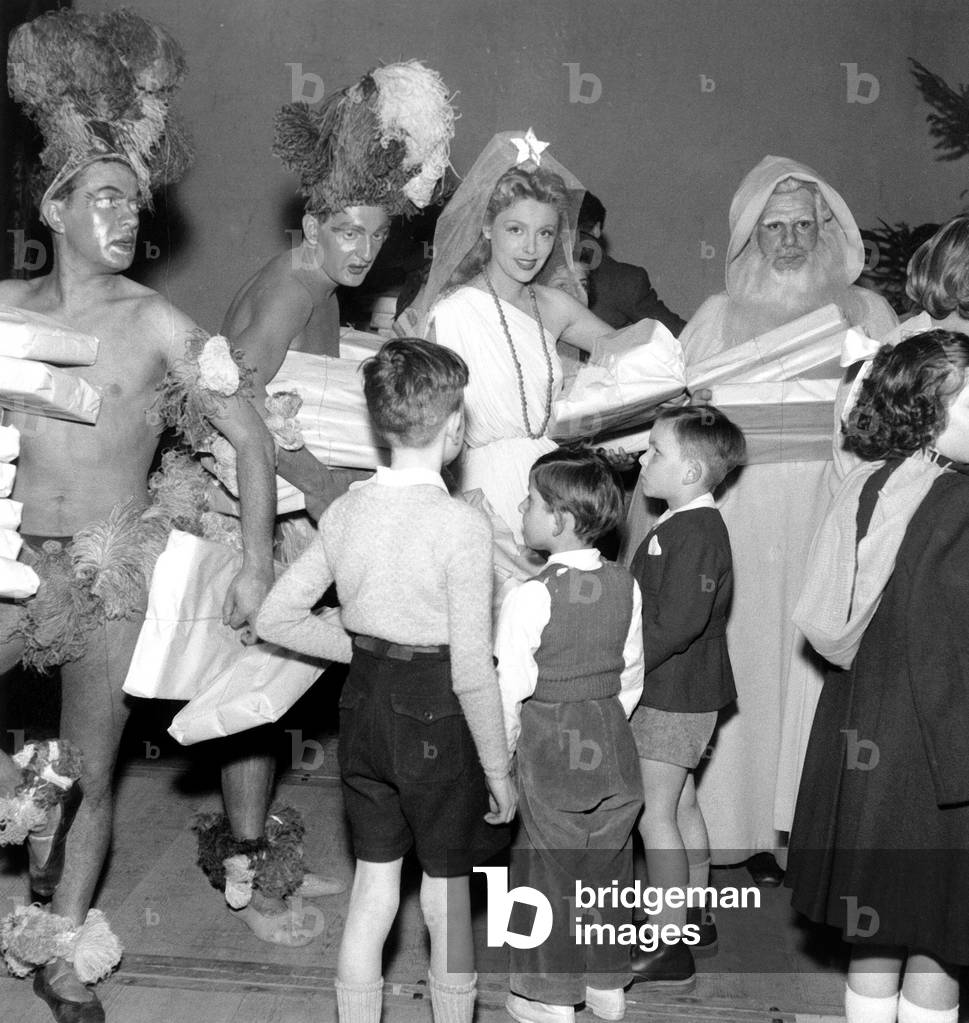 French Actors Michel Galabru Dressed As Father Christmas With Marie Sabouret at Christmas Show For The Children of French Comedy Staff December 1951 (b/w photo)