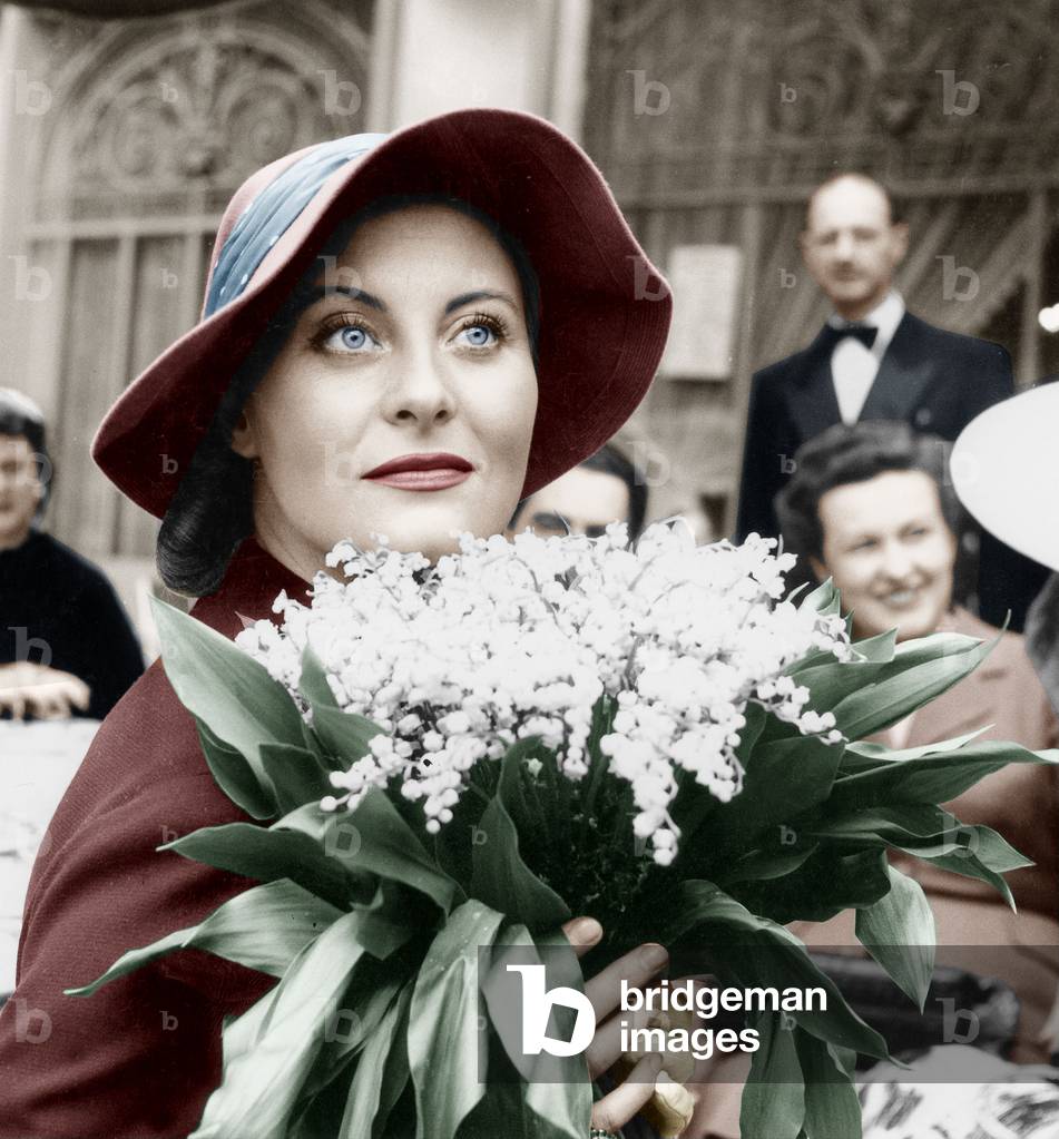 French Actress Michele Morgan Holding Bunch of Flowers Lily of The Valley on May 1St, 1952 (photo)