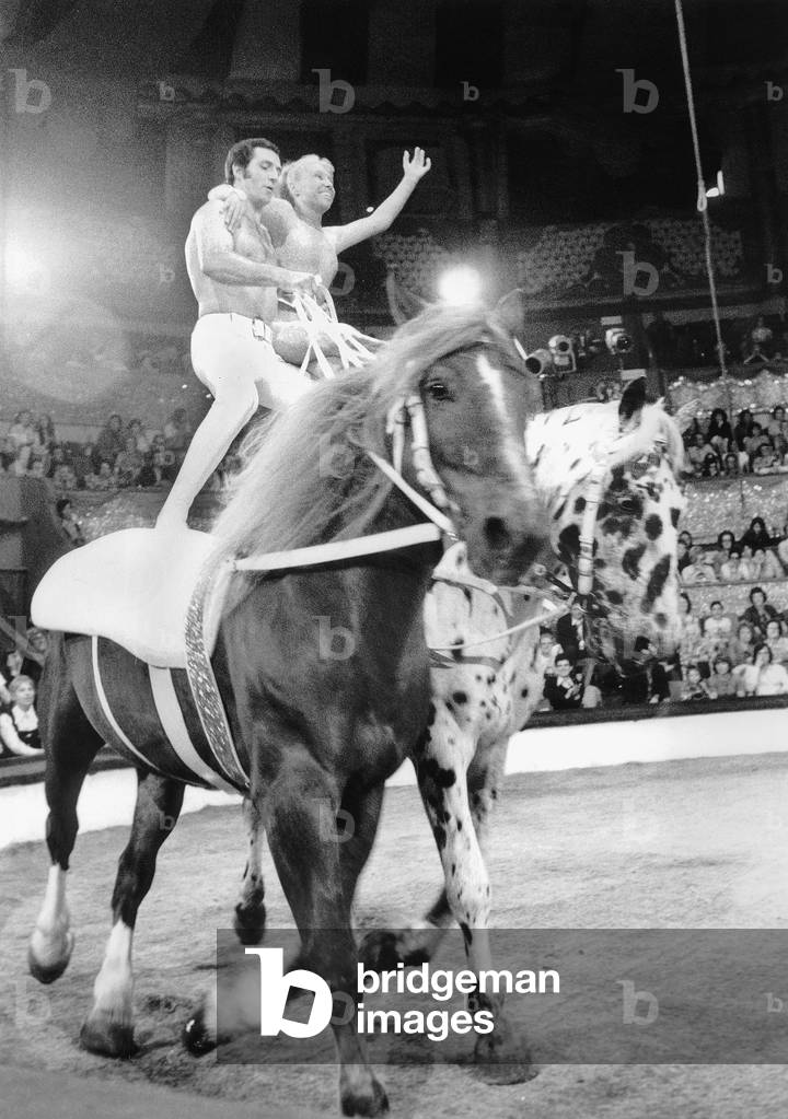 Silvia Montfort and Alexis Gruss Standing on Horses during Rehearsal For Circus Show June 20, 1974 (b/w photo)