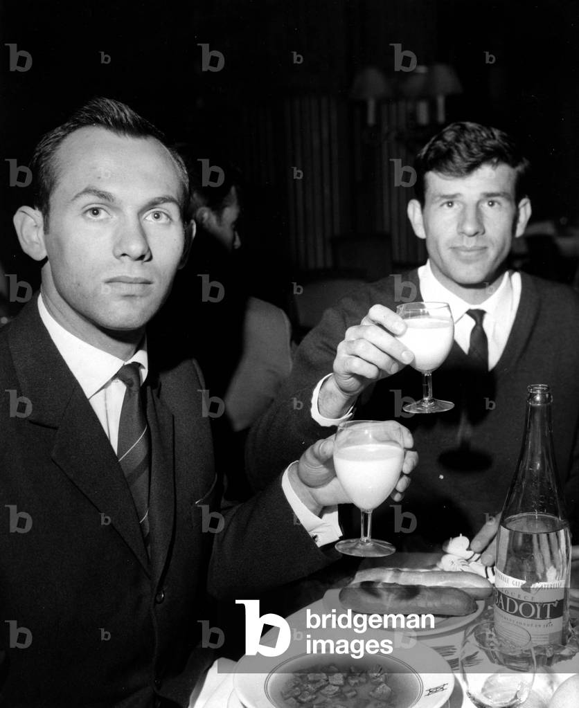 The Two Sovietics Valeri Brumel (High Jump) And Igor Ter Ovanessian (Long Jump) Have Drink With A Glass Of Milk In Paris For The France Russia Athletics Meeting On October 1st 1965 (b/w photo)