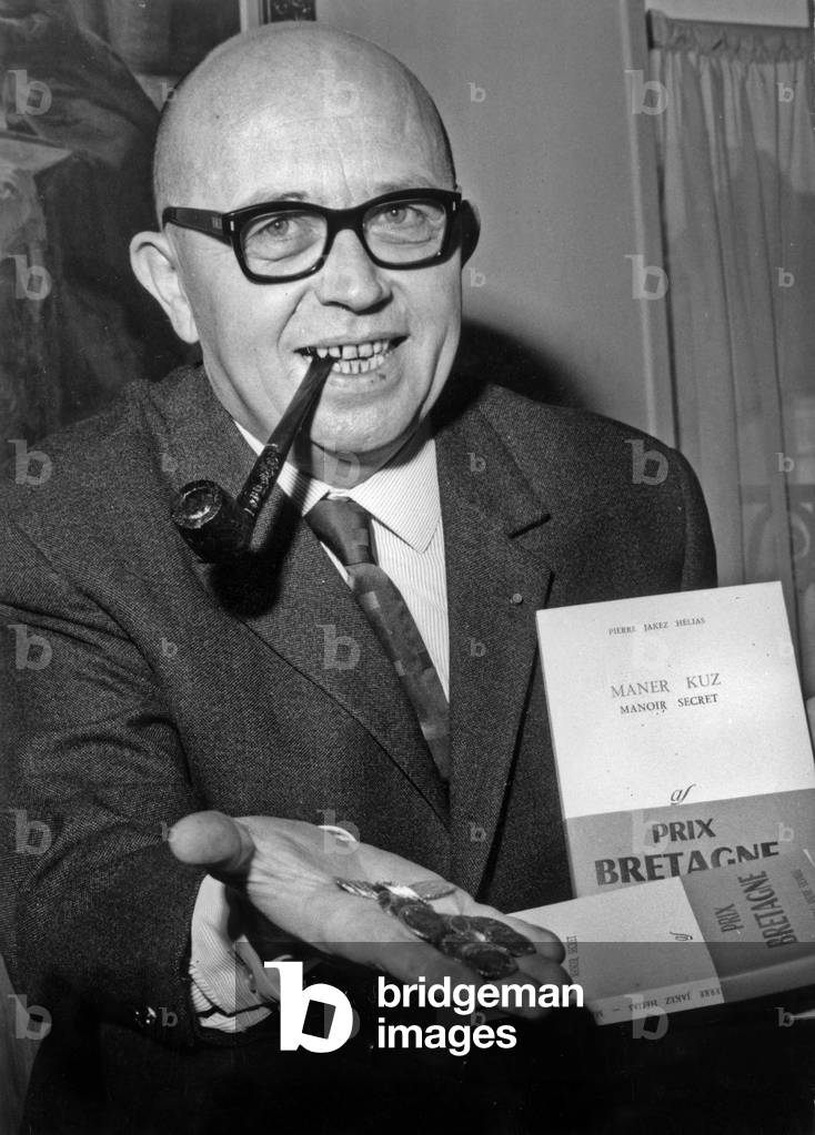 Pierre Jacques Helias Signing His Books And Showing The Golden Louis He Just Receive For His “Prix Bretagne” December 10, 1964 (b/w photo)