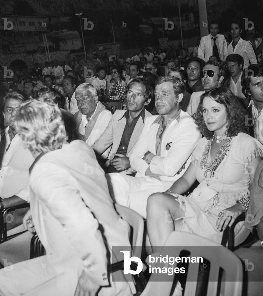 French actor Jean Paul Belmondo and Italian actress Laure Antonelli attending the CarlosMonzon vs RodrigoValdes boxing match in Monaco on June 29, 1976 (b/w photo)