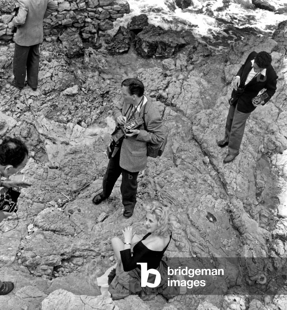 Janine Clair and Photographers during Cannes Festival May 6, 1957 (b/w photo)