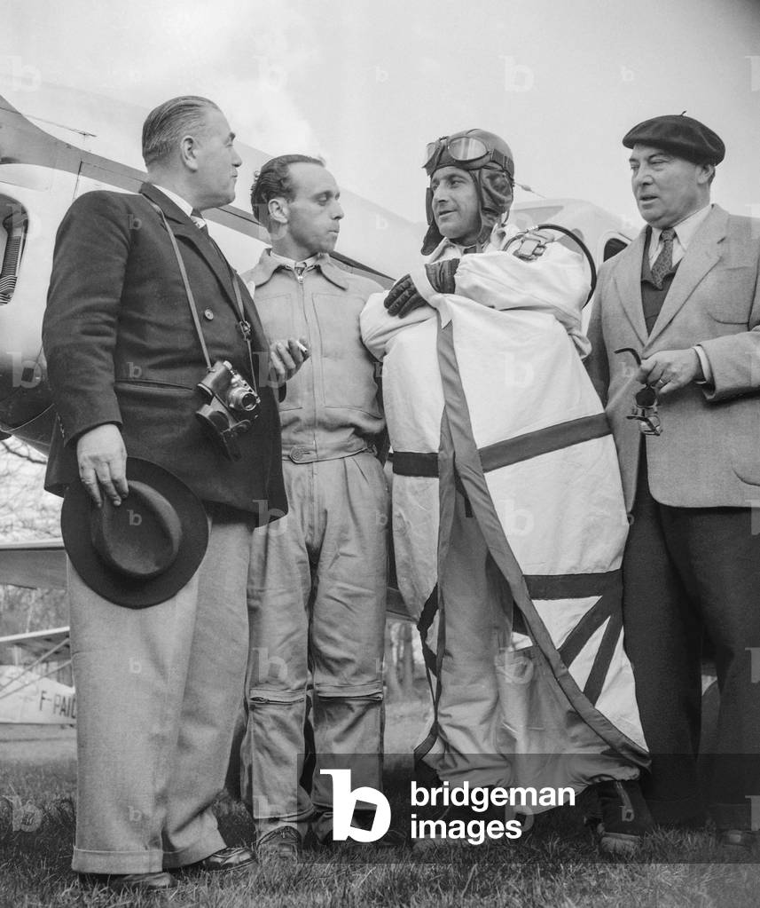French parachutist Valentin presenting his wingsuit (to be a bird man)in Villacoublay, France, April 15, 1950 (b/w photo)