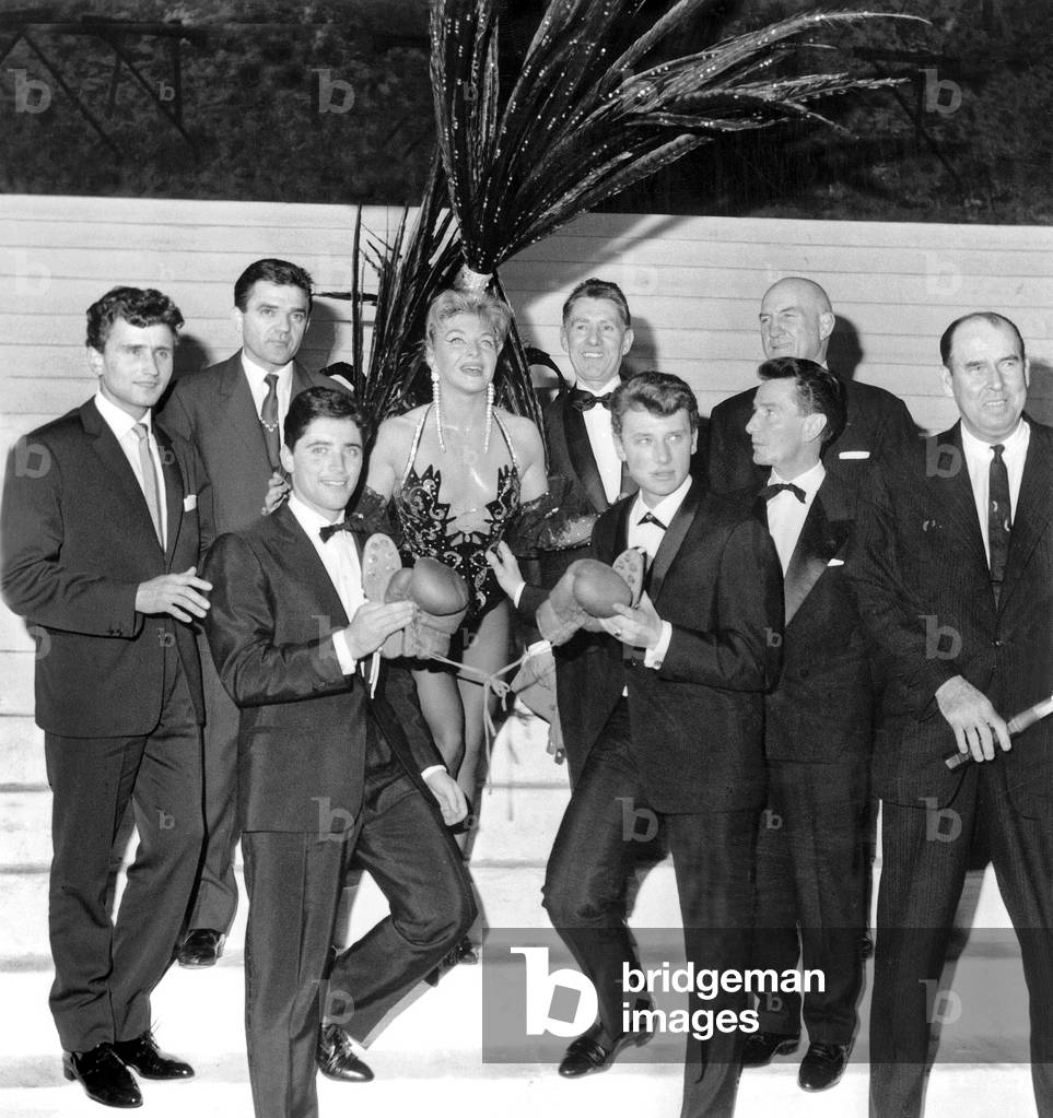 Line Renaud With Johnny Hallyday, Sacha Distel, Michel Jazy, Joseph Vjlaki, Jules Ladounegue, Roger Poncelet, Marcel Thill, Yvon Petra at 1000Th of Revue Pleasures in Parisian Cabaret December 14, 1961 (b/w photo)