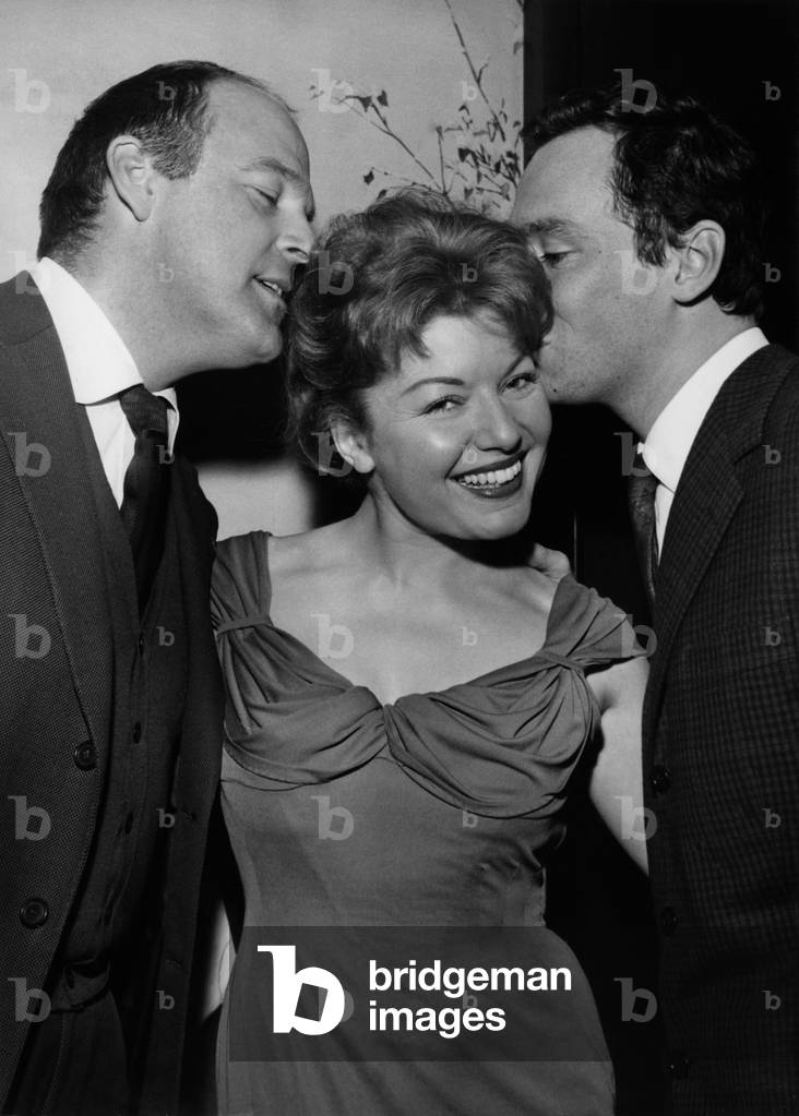 Claudine Dupuis, Before Depart For South America For The Film La Feu, Reunited Her Friends At L'Elysees Matignon During A Cocktail. Here with Bill Marshall and Maurice Ronet. February 9, 1957 (b/w photo)