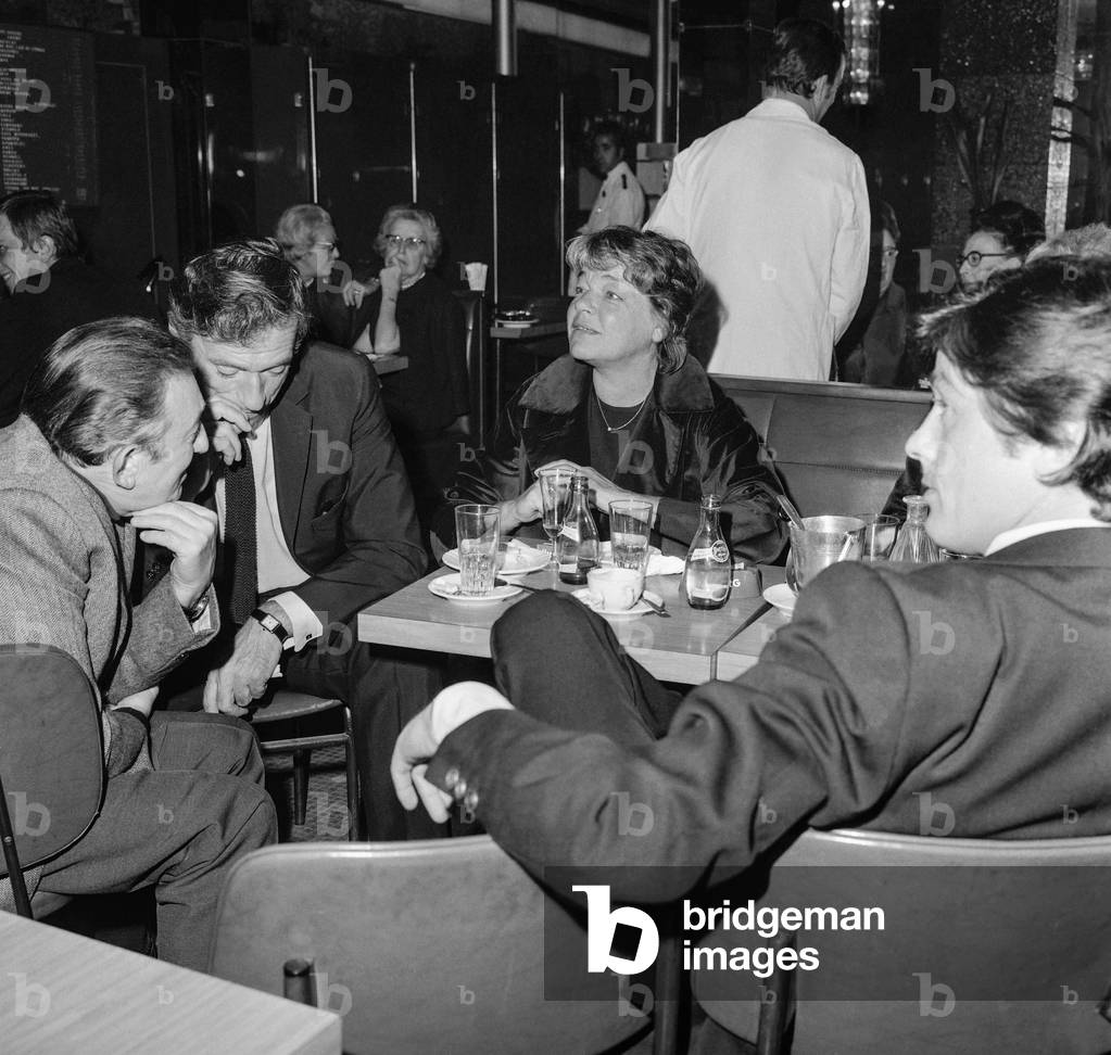 Yves Montand, Simone Signoret and Alain Delon at a cafe, Paris, October 14, 1971 (b/w photo)