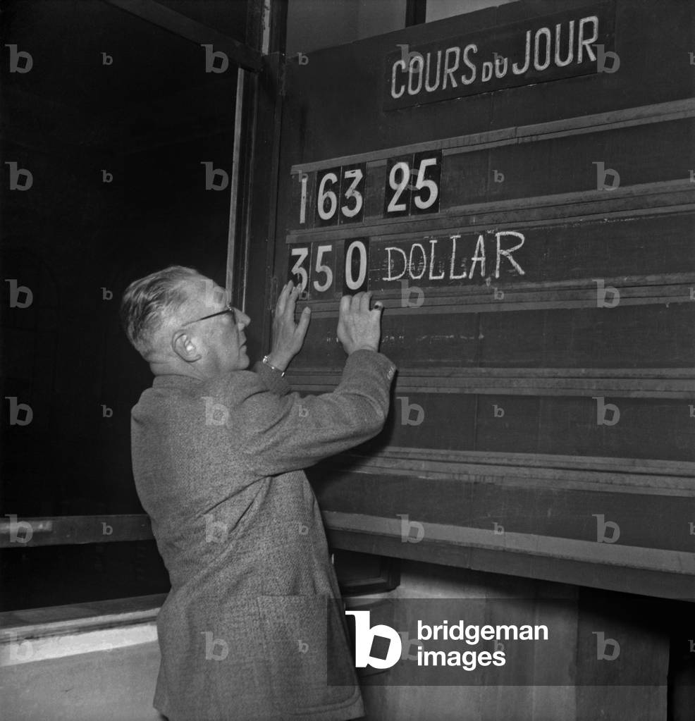 Devaluation of Franc in September 1949 : Display of The New Exchange Rate : 350 French Francs = Us (b/w photo)