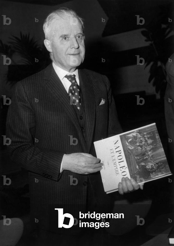 Jean Mistler De L'Academie Francaise Holds Le Livre Napoleon Et L'Empire Edite By Hachette Qu'il Has Realise With 30 Historiens At La Maison De L'Ortf In Paris, 12 December 1968 -Jean Mistler of The Academy Francaise Holding his Book Napoleon and the Empire at The House of Ortf in Paris, December 12, 1968 (b/w photo)