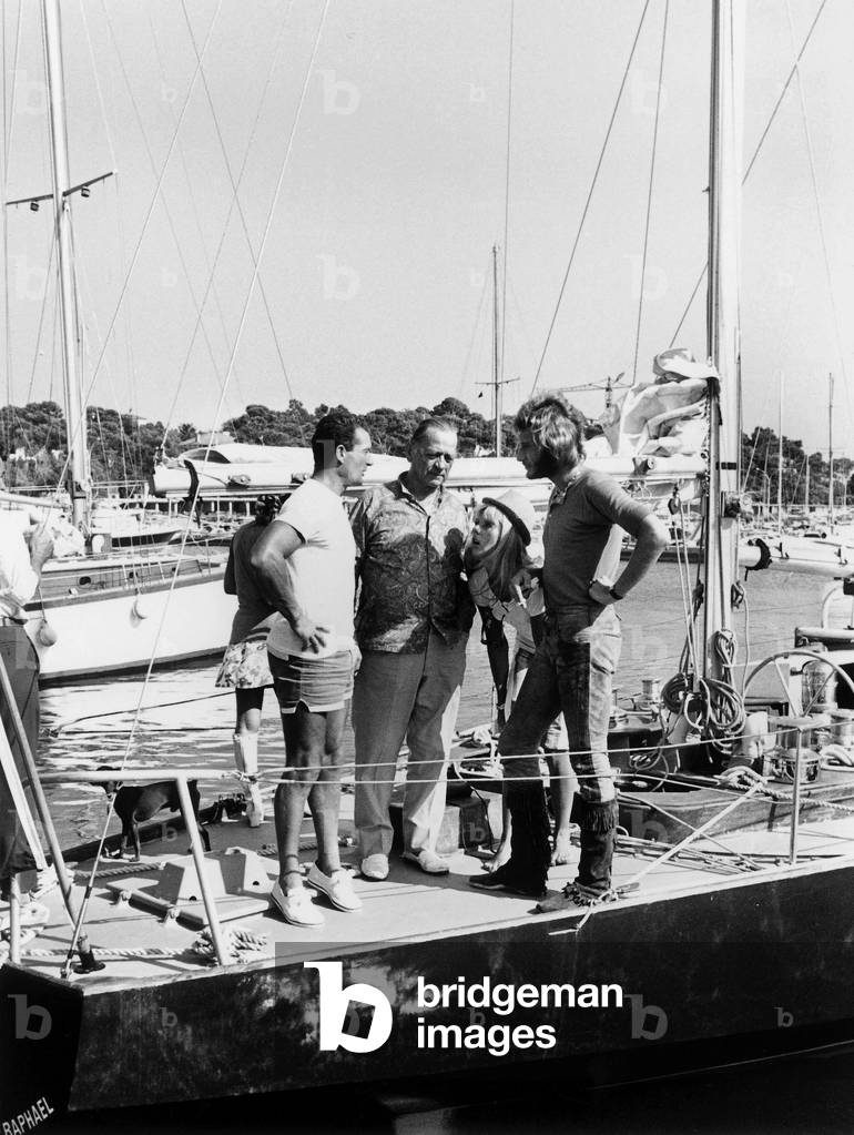 French Navigator Eric Tabarly With Singers Henri Charriere, Sheila and Johnny Hallyday in Holidays in Saint Raphael Cote D' Azur Riviera August 22, 1969 (b/w photo)
