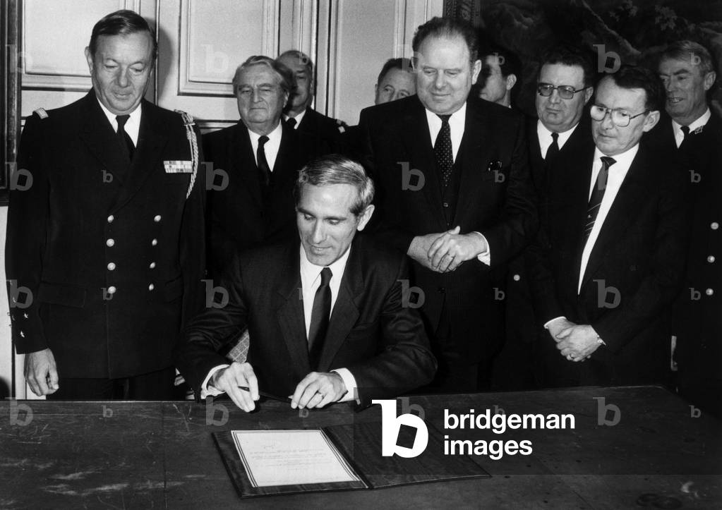 Paul Quiles French Minister of Defence Signing Order For A New French Aircraft Carrier Richelieu on February 4, 1986 in Presence of Admiral Lennhardt (L) and Emile Blanc at French Ministry of Defence, Paris (b/w photo)
