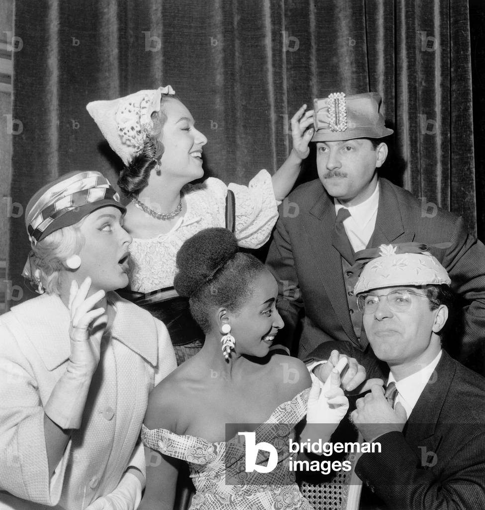Actors Jean Poiret and Michel Serrault Looking at Ready-To-Wear Fashion Show presented by Miss France Overseas (L) and Yolande Magny November 26, 1956 (b/w photo)
