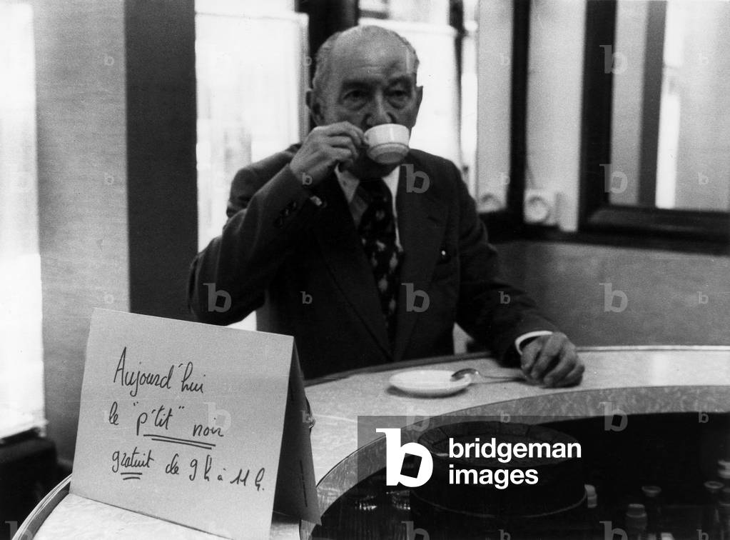 Man Buvans His Cafe Au Comptoir D'Un Cafe In Paris Dans Les Annees 70. (b/w photo)