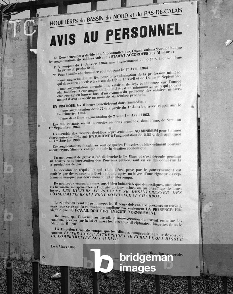 Miners on strike in north of France, March 6, 1963 : in Dechy, poster inviting the miners to stop the strike and announcing increase of salaries (b/w photo)