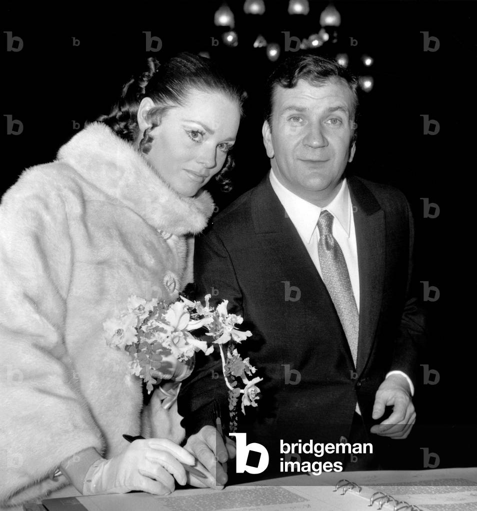 Wedding of Annie Fournier and Pierre Mondy in Paris December 16, 1967, here Signing The Weddings Book (b/w photo)