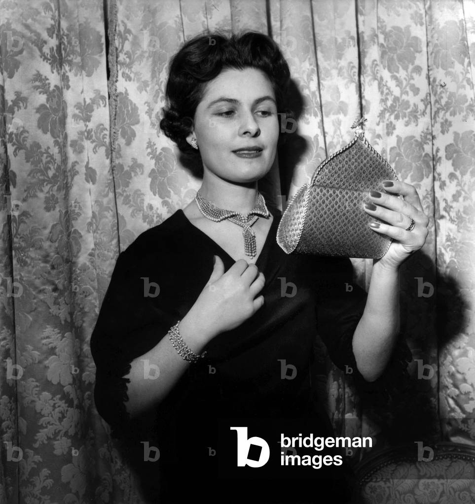 Young Woman Showing A Gold and Turquoise Necklace and Bracelet, and A Gold Material Bag December 1St, 1960 By Boucheron (b/w photo)