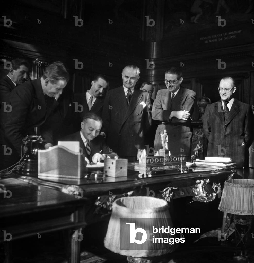 Signature of Aerial Agreement Between France and Brazil in Paris on January 27, 1947 : Georges Bidault, French Minister of Foreign Affairs, Signing Under Look of Jules Moch and Frederico De Castelo Branco Clark (b/w photo)