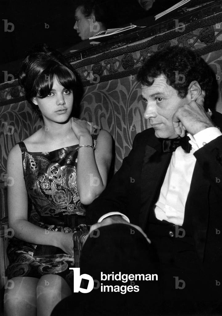 French Actor and Film Director Christian Marquand (1927 - 2000) With his Wife Marie-Christine, at The Champs Elysees Theatre. Paris, France, December 5, 1963 (b/w photo)