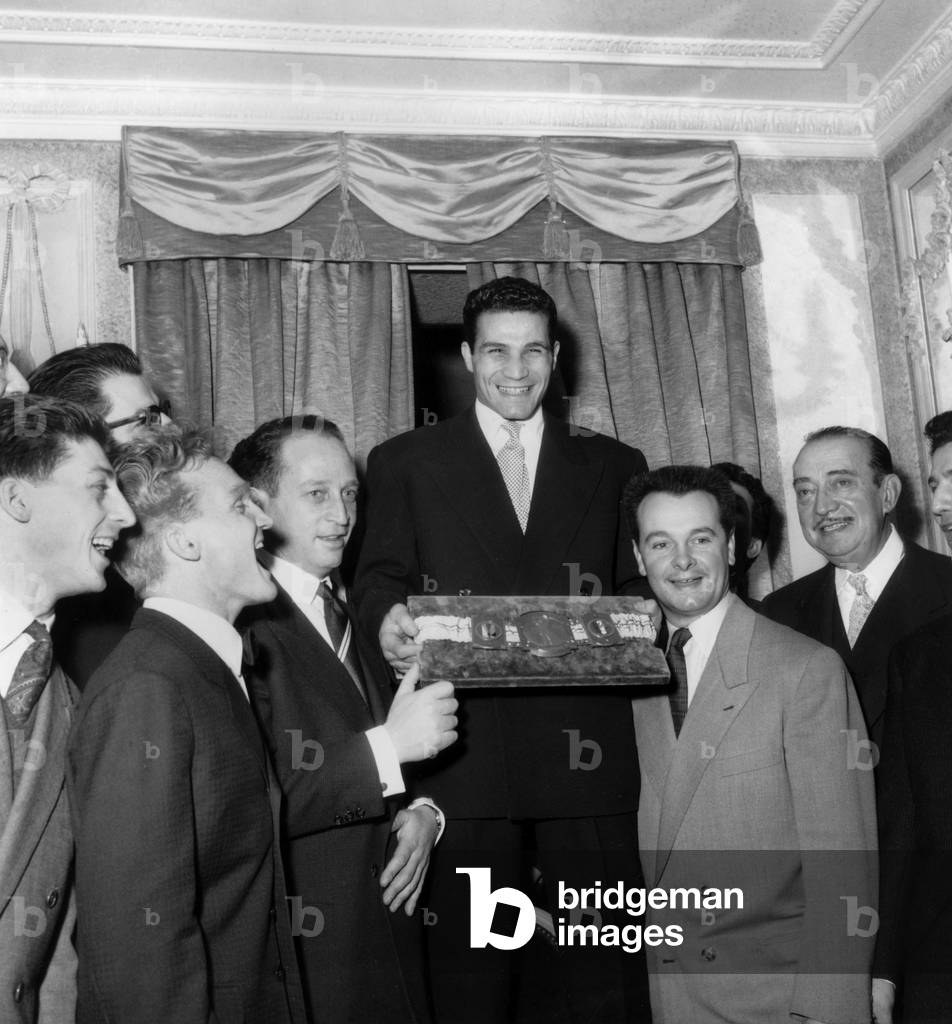 Robert Cohen Receiving Belt of World Champion of Boxe in Presence of French Singers Compagnons De La Chanson December 30, 1954 (b/w photo)