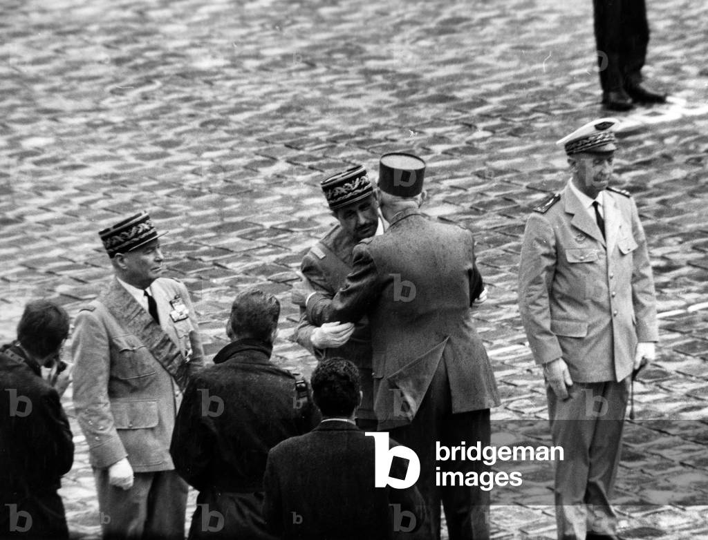 General De Gaulle Decorant 3 Generals: On the Right The General Dodelier, The General Dio (Kissing By De Daulle) And On the Left The General Accard In The Court Of Honour Of The Invalides July 22, 1965 (b/w photo)