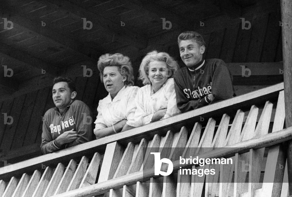 Cyclist Stablinsky (L) and Jacques Anquetil With Their Wives Watching Amateur Cycling Race From Their Hotel Room in Salanches September 06, 1964 (b/w photo)