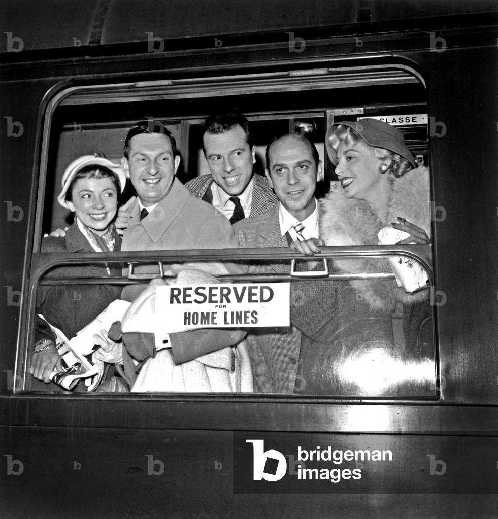 Actors Micheline Boudet, Jacques Charron, Jean Myer, Robert Manuel and Marie Sabouret of The French Comedy Before Departure For Tour in Canada and United States September 15, 1955 - Train (b/w photo)