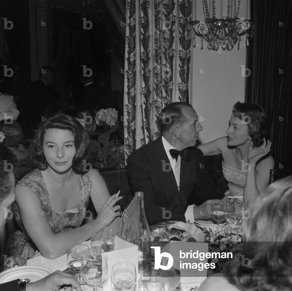 British-American actress Olivia de Havilland and French model Bettina (Graziani) at a dinner on June 25, 1957