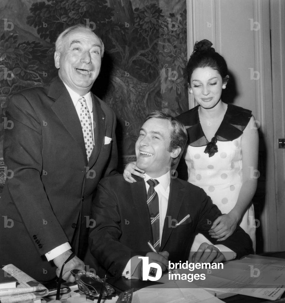 Michel Duchaussoy and Claire Vernet Signing Their Contract at The French Comedy Under The Eye of Maurice Escande July 07, 1964 (b/w photo)