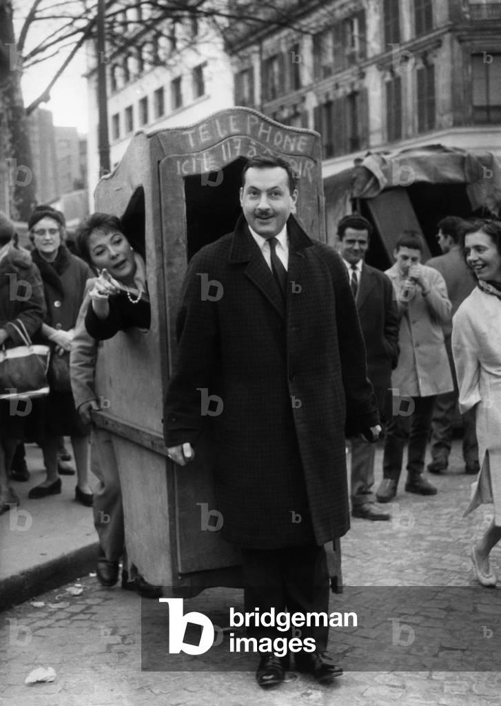 French Actor Michel Serrault With A Sedan Chair Carrying Francoise Fleury, April 7, 1962. Paris, France (b/w photo)
