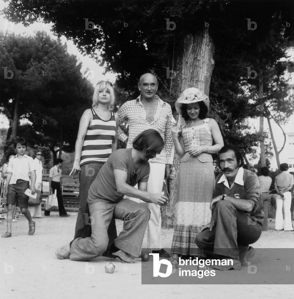 Eddie Barclay, Sophie Daumier, Jassilini Farid during A Game of Boules, 1974 (b/w photo)
