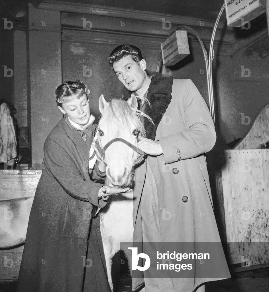 Rehearsal of the Gala of Union, Cirque d'Hiver, Paris, February 11, 1952 : French actors Dany Robin and Georges Marchal with a pony (b/w photo)
