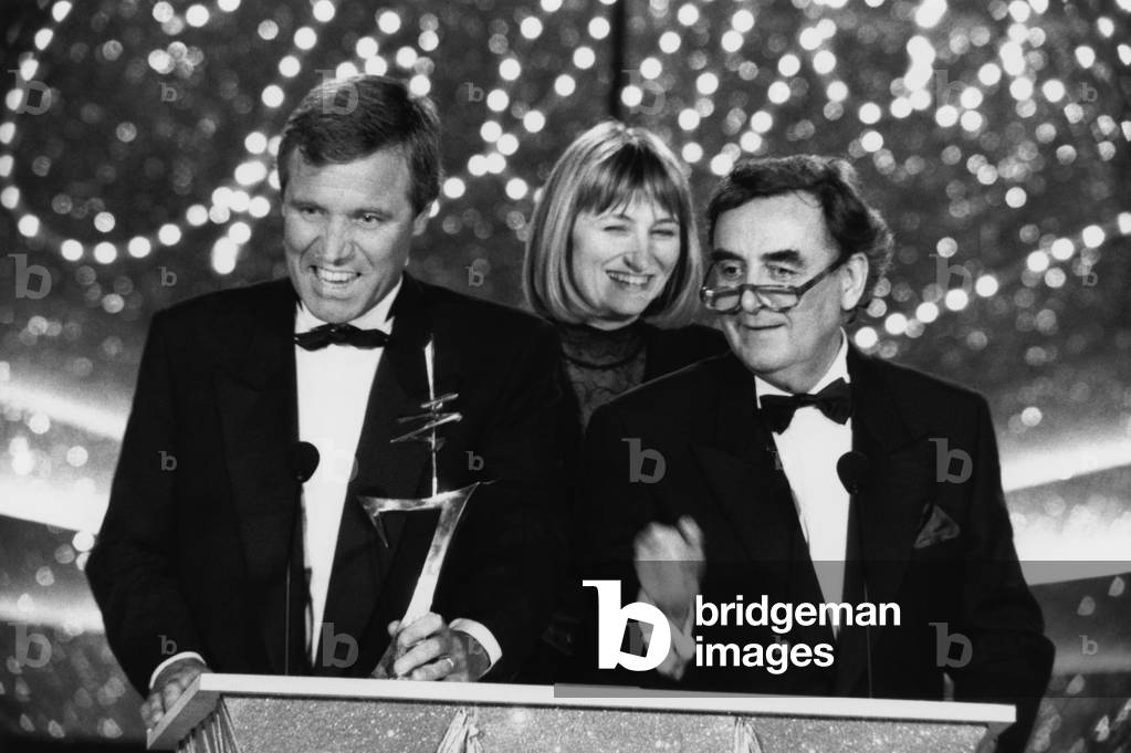 Bruno Massure received Le 7 D'Or From Best Presenter Of The Newspaper Televise During The Ceremony Of The 7 D'Or Gala That Was Deroulait At The Moulin Rouge. This is in the Company of Christine Bravo And Bernard Pivot. January 19, 1993 (b/w photo)