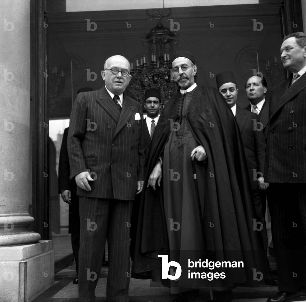 King Idris of Libya (Muhammad Idris As-Senussi) during his Visit in Paris : Leaving Elysee Palace After Lunch With French President Vincent Auriol (L) on October 21, 1953 ; on R : French Prime Minister Joseph Laniel (b/w photo)